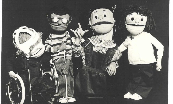 4 puppets are pictured, Mark who has CP and uses a wheelchair, Reanaldo who has a visual impairment, Many who has a hearing impairment and is making the sign for I Love You and Ellen Jane who has Down syndrome.